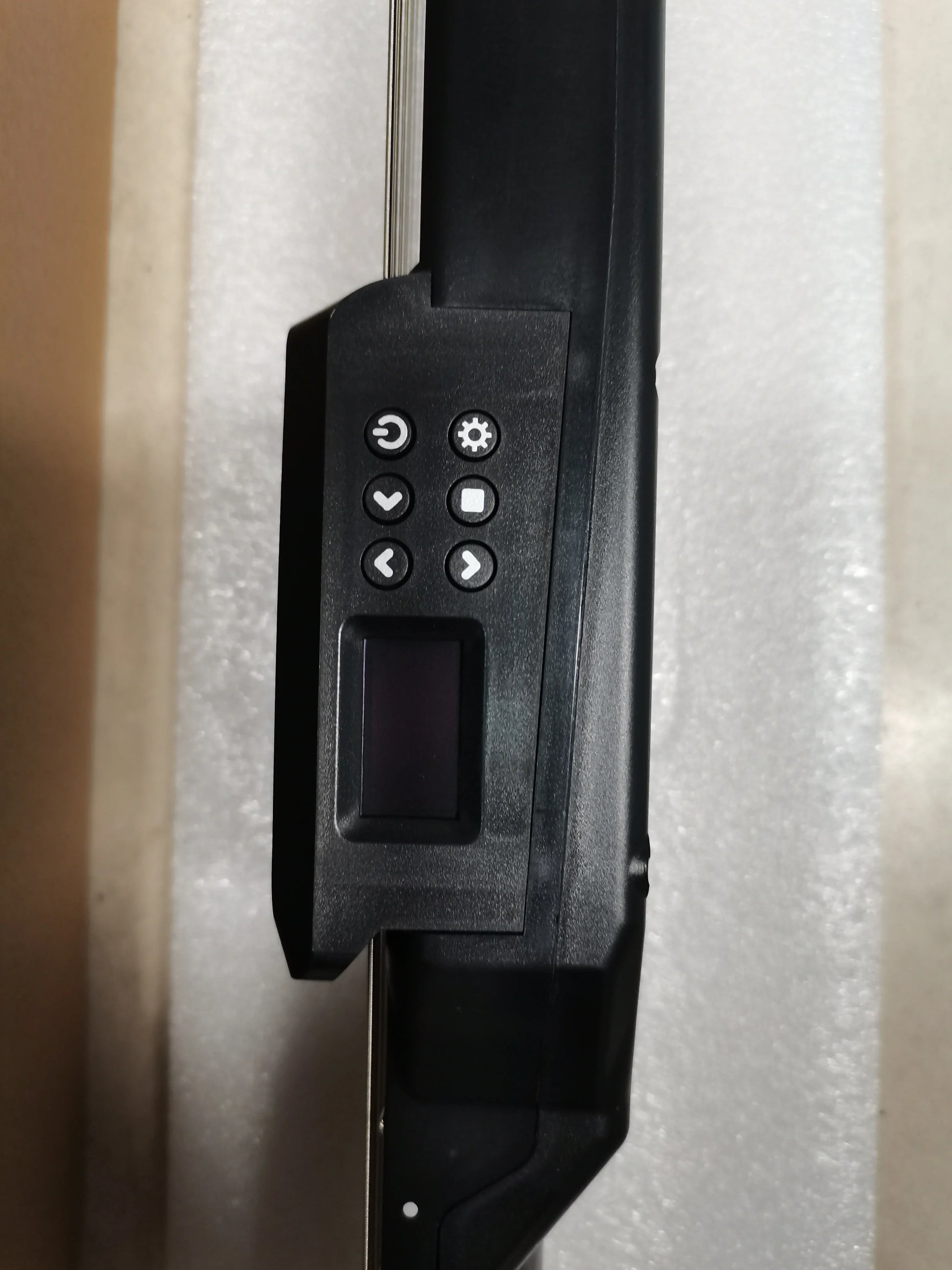 Black plastic control panel with six circular buttons and display screen on smart electric guitar silent digital tuner metronome