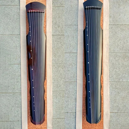 Two traditional guqin zither handmade instruments in dark reddish brown and black with seven strings and white dot markers accessories chinese traditional