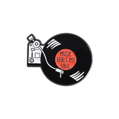 Black enamel pin featuring a 90s retro music vinyl record design with white grooves and orange center for enamel pins vintage collection