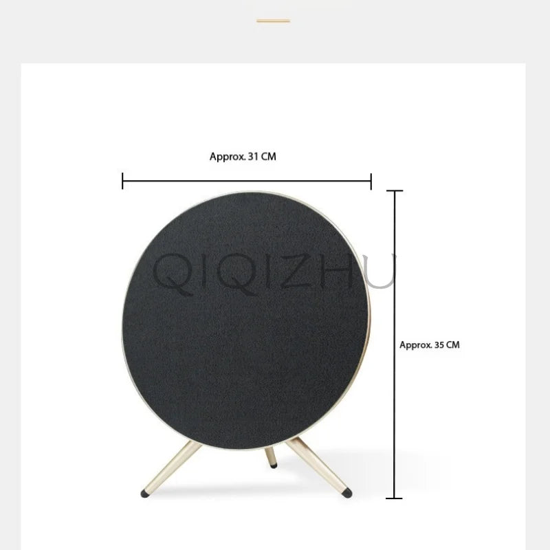 Black circular home theater bluetooth speaker with matte finish and metallic legs subwoofer outdoor portable design