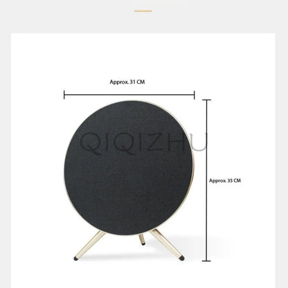 Black circular home theater bluetooth speaker with matte finish and metallic legs subwoofer outdoor portable design