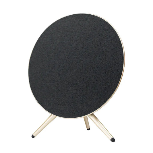Black circular home theater bluetooth speaker with textured surface and three light-colored slender legs for outdoor use