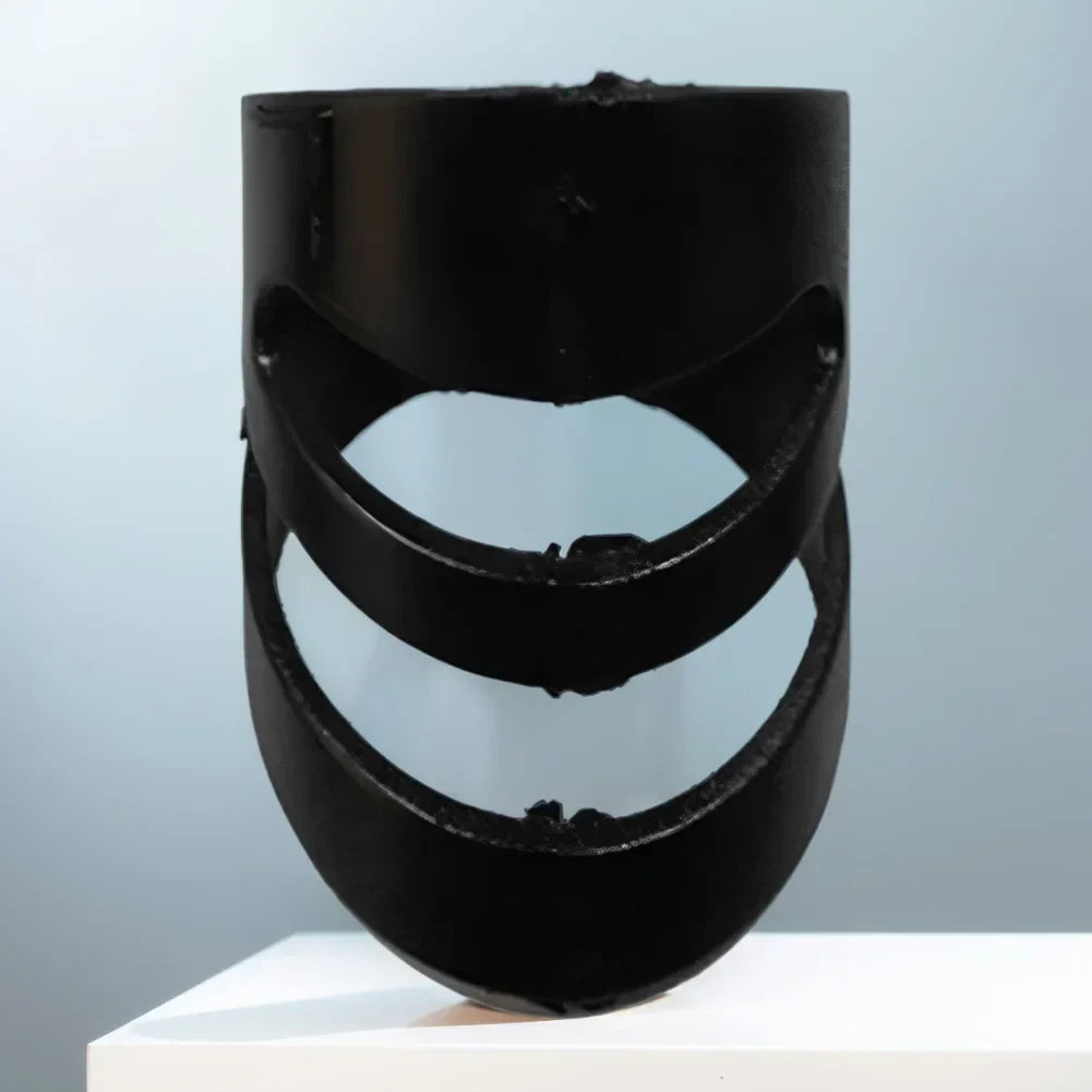 Black cylindrical sculpture with three concentric curved cutouts featured in alaska picks plectrums guitar finger covers