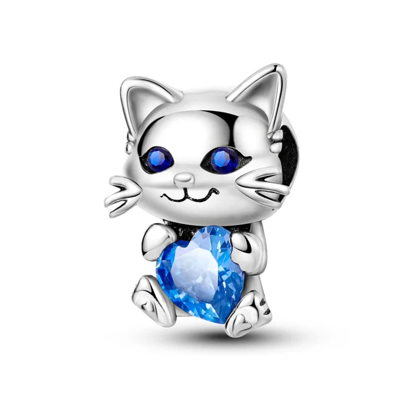 Silver cat charm with blue gemstone eyes holding a sparkling heart made of 925 sterling silver music for original bangle bracelet