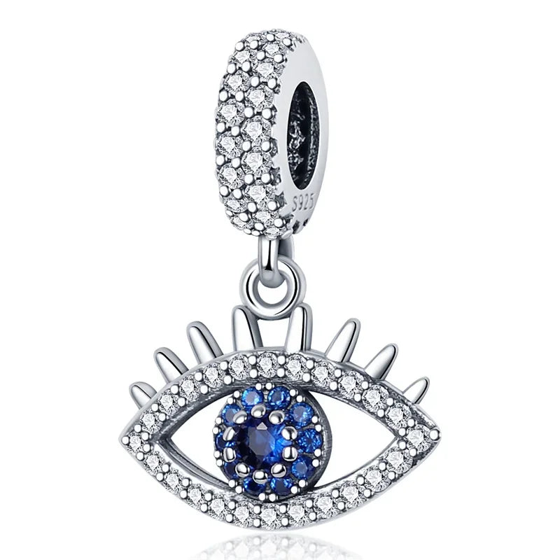 Silver evil eye charm with blue gemstone center and crystals designed as sterling silver music bead for original bangle bracelet