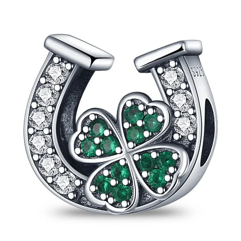 Silver horseshoe-shaped sterling silver music charm with clear and green gemstones and clover design for original bangle bracelet