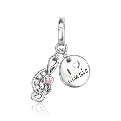 Silver sterling silver musical infinity charm with clear crystals and pink gemstone and round disc engraved i heart music