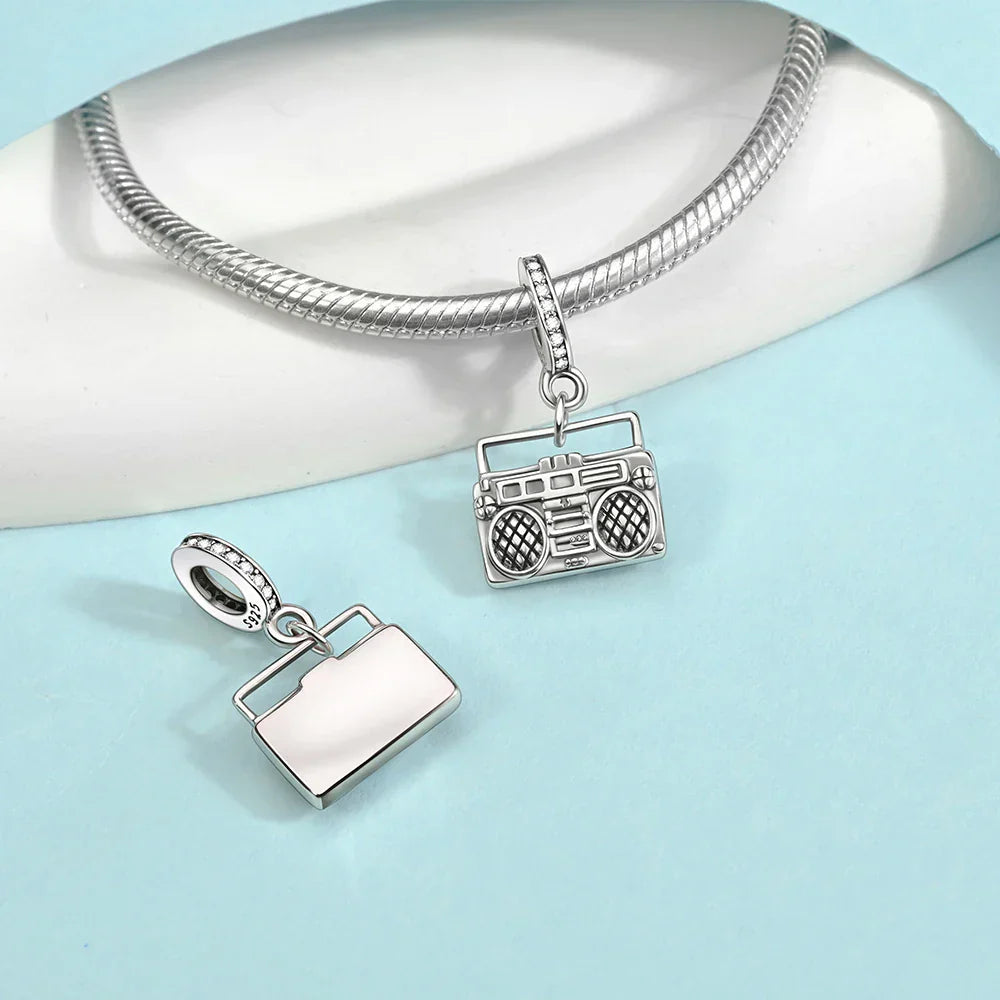 Silver charm set featuring detailed boombox and handbag designs with diamond accents for sterling silver musical instrument charms