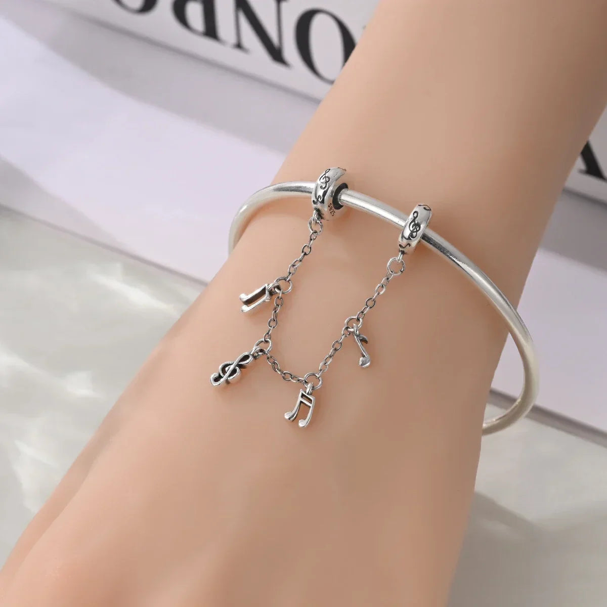 Silver sterling silver musical charm bracelet with dangling musical instrument charms and guitar earphone pendants