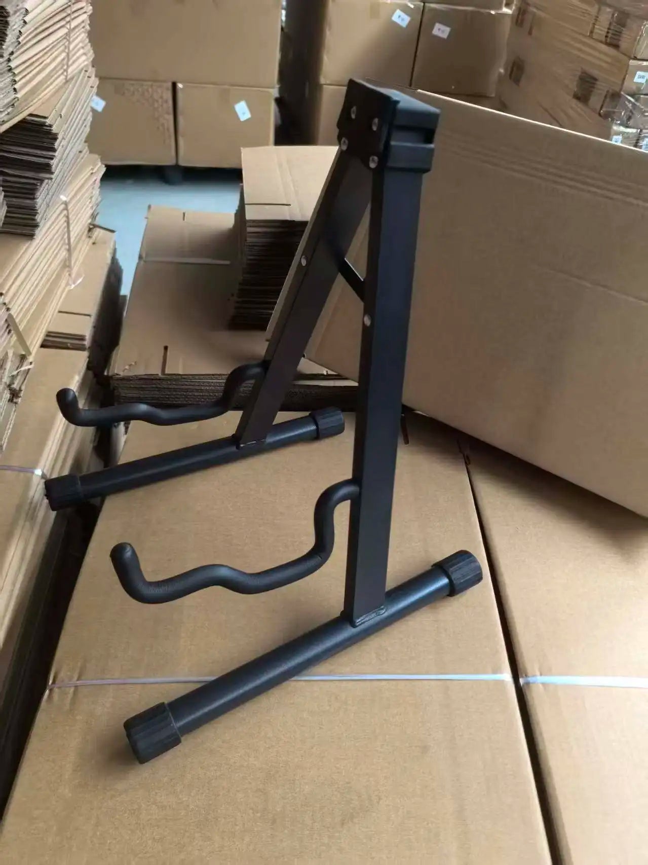 Black metal guitar stand with adjustable arms and sturdy base for acoustic electric guitar and bass stable portable use