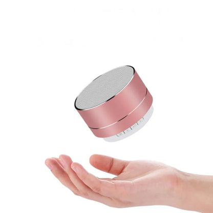 Rose gold cylindrical portable bluetooth speaker with silver mesh grille supports tf card and delivers perfect sound outdoors