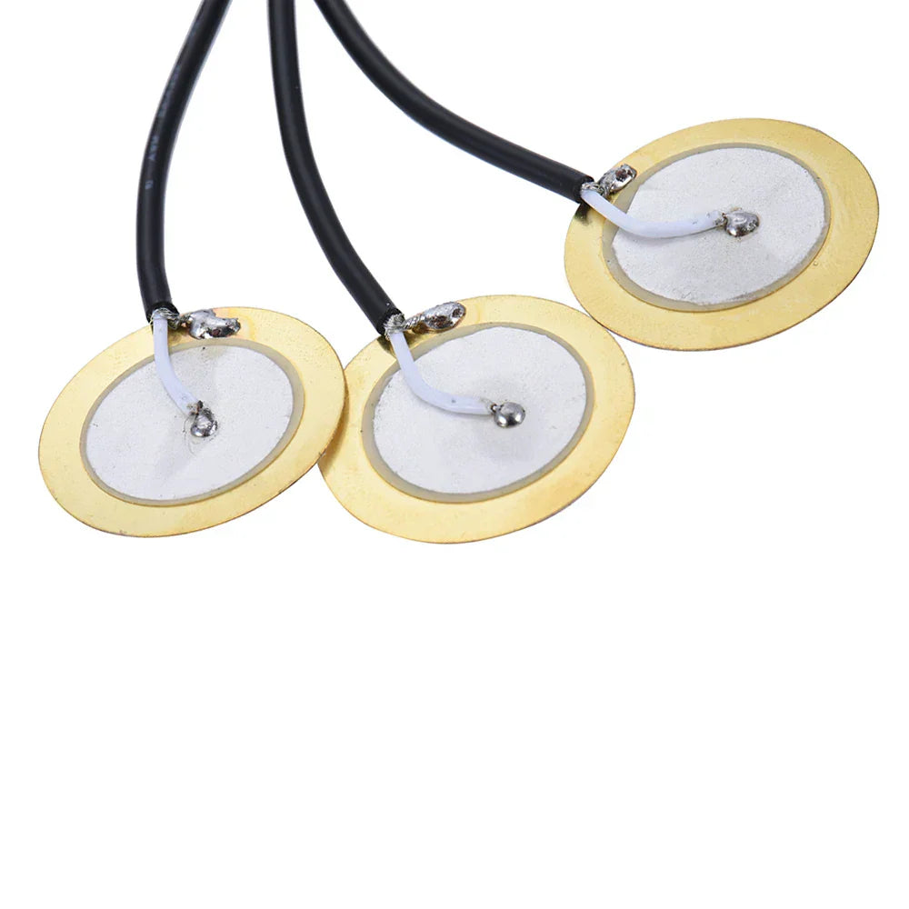 Three circular gold-edged electrode pads with black cables and silver connectors for guitar mandolin ukulele pickup system