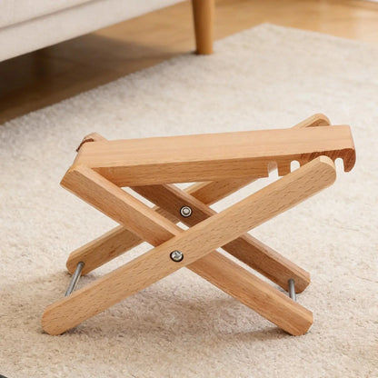 Light-colored wooden adjustable guitar foot stool with metal hinges ergonomic leg rest for classical guitar home use
