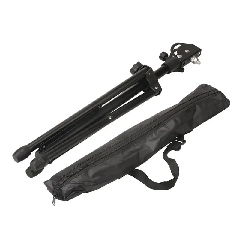 Black adjustable metal drum tripod practice pad with adjustable legs and matching carrying case for music accessories