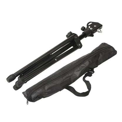 Black adjustable metal drum tripod practice pad with adjustable legs and matching carrying case for music accessories