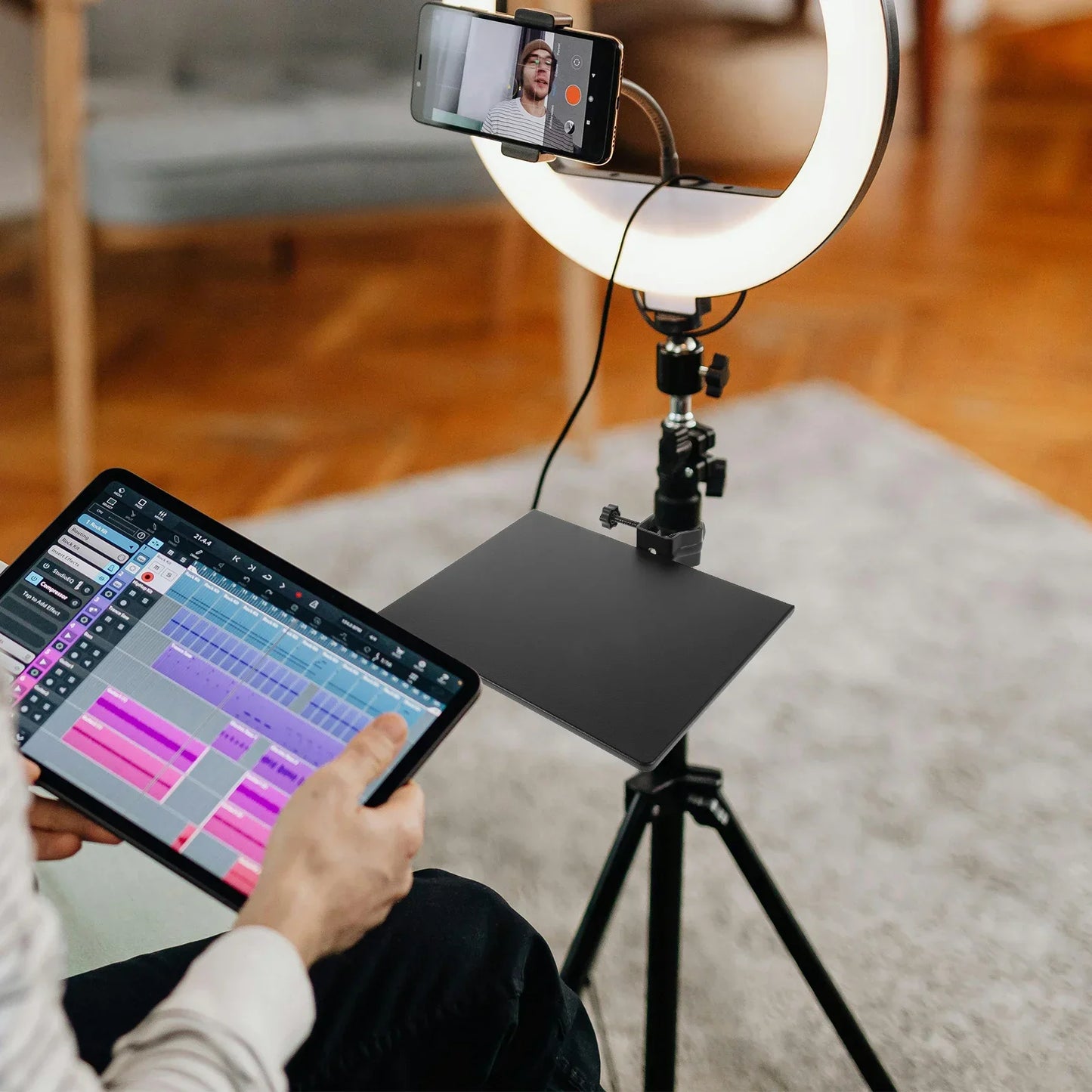 White circular ring light on black tripod with adjustable arm holding smartphone and adjustable microphone stand tray metal clamp-on organizer for live streaming karaoke