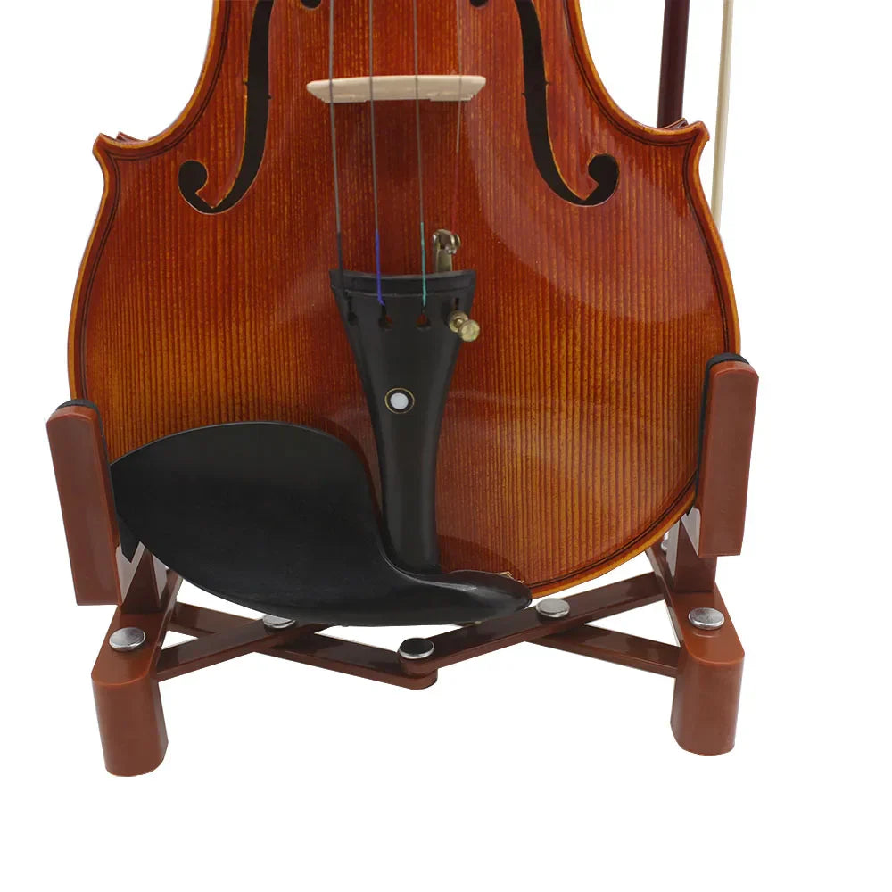 A polished warm amber-brown violin with gloss finish rests on an adjustable portable retractable foldable fiddle bracket sponge stand