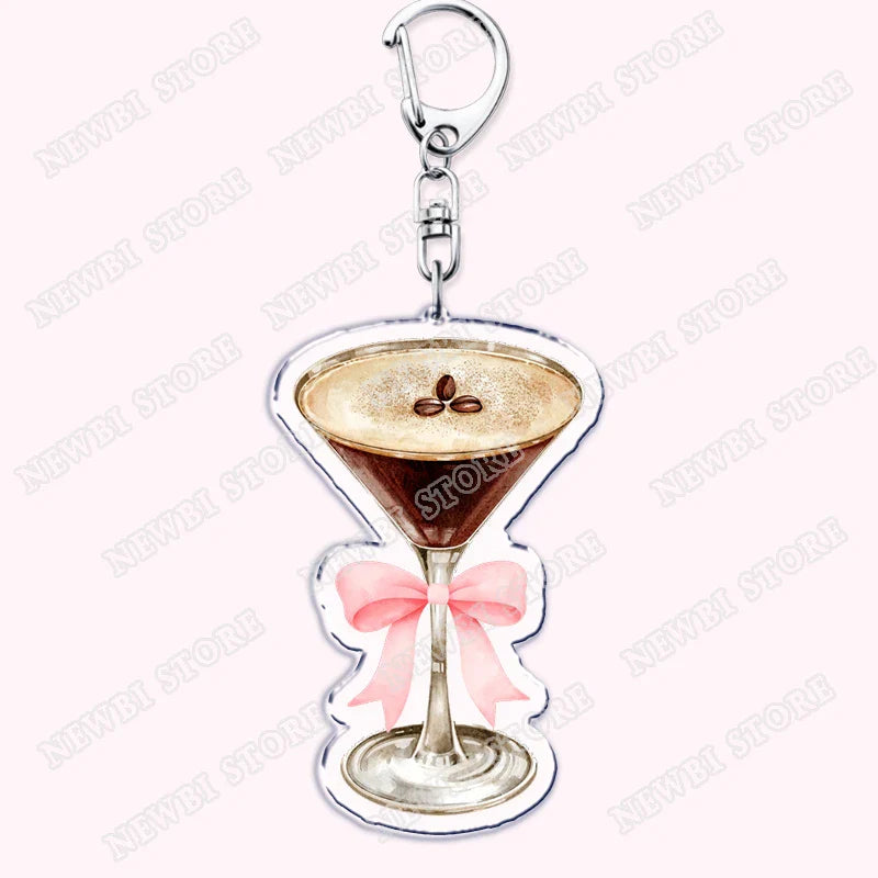 A clear acrylic aesthetic coquette pink keychain shaped like a martini glass with a pink bow and coffee beans for womens accessories ribbon and hot girl book club gifts
