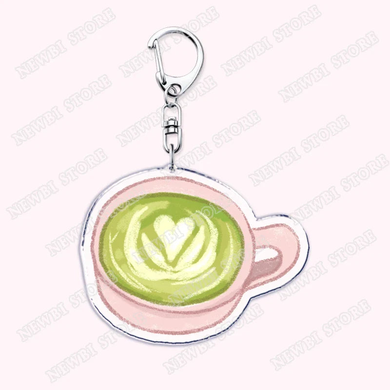 Pink acrylic keychain featuring an illustrated matcha latte with heart foam art for aesthetic coquette pink womens accessories ribbon and hot girl book club gifts