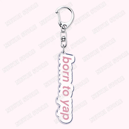Silver acrylic keychain with born to yap pink lettering from aesthetic coquette pink womens accessories ribbon collection