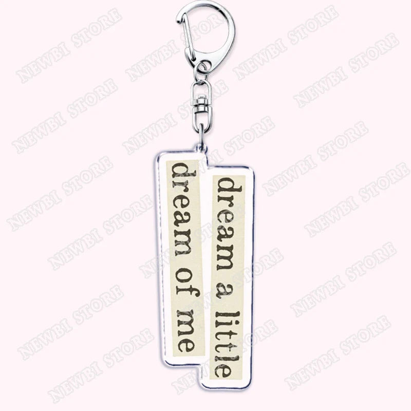 Silver rectangular keychain with cream panels and dream a little dream of me phrase for aesthetic coquette pink womens accessories ribbon hot girl book club gifts