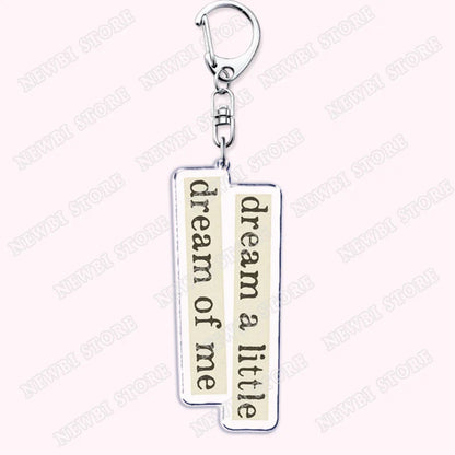 Silver rectangular keychain with cream panels and dream a little dream of me phrase for aesthetic coquette pink womens accessories ribbon hot girl book club gifts