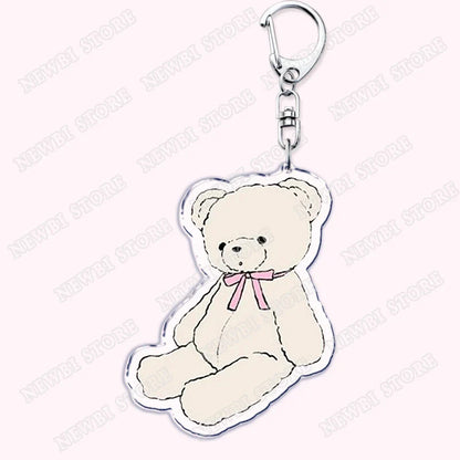 Cute cream-colored acrylic keychain featuring a sitting teddy bear with pink bow for aesthetic coquette pink womens accessories ribbon