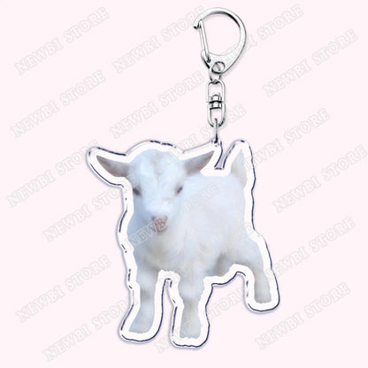 A white acrylic keychain with a baby goat cutout and silver edges for aesthetic coquette pink womens accessories ribbon gifts