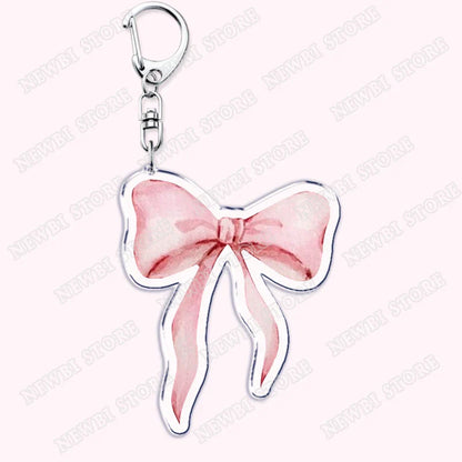 A delicate aesthetic coquette pink bow keychain with silver clasp for womens accessories ribbon and hot girl book club gifts