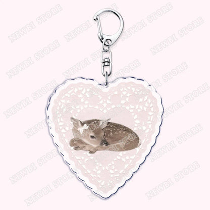Heart-shaped aesthetic coquette pink keychain with silver clasp and lace border featuring sleeping fawn for womens accessories ribbon and hot girl book club gifts