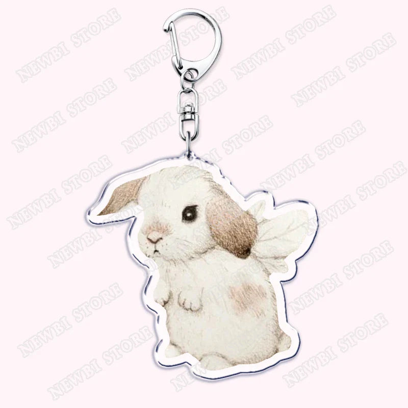 A clear acrylic aesthetic coquette pink keychain featuring a cute white bunny with brown ears for womens accessories ribbon gifts