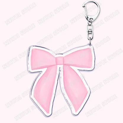Pink enamel bow-shaped keychain with silver metallic outline and clasp for aesthetic coquette pink womens accessories ribbon and hot girl book use