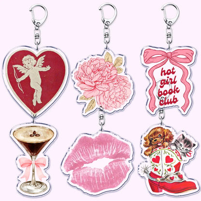 Set of six clear acrylic aesthetic coquette pink keychains featuring womens accessories ribbon and hot girl book club designs