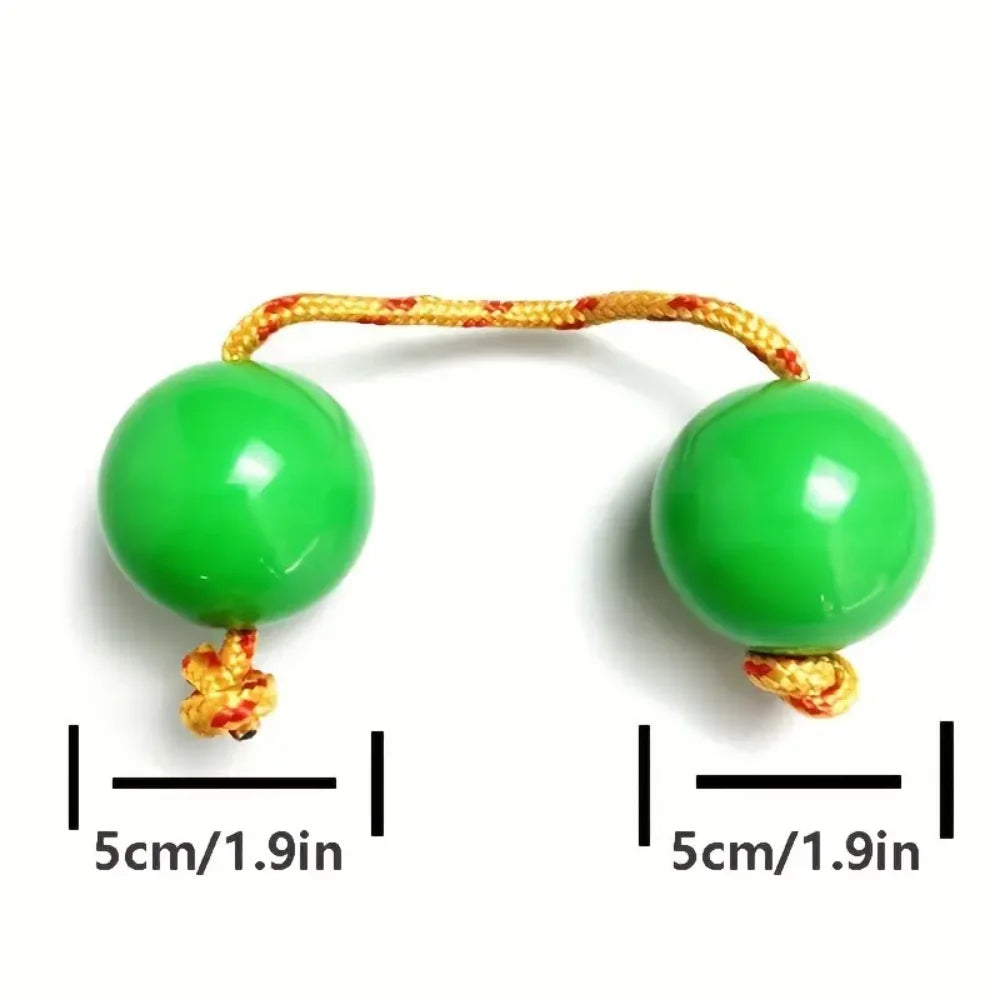 Vibrant green jade spheres connected by a golden braided cord african shaker kashaka rhythmic balls instrument