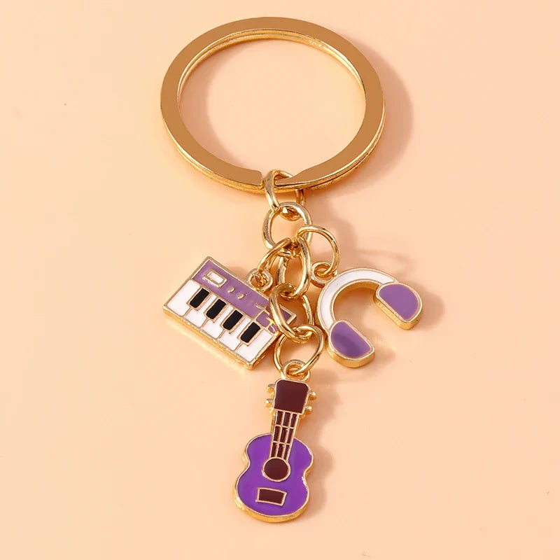 Gold-toned aihua alloy metal keychain with purple and white enamel musical instrument charms for diy handbag pendant