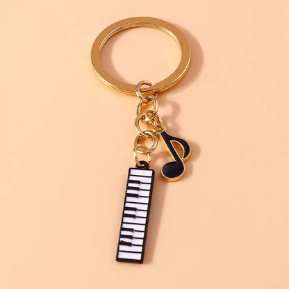 Gold-toned aihua alloy metal enamel musical instrument keychain with black and white piano keyboard and musical note charms for diy handbag pendant