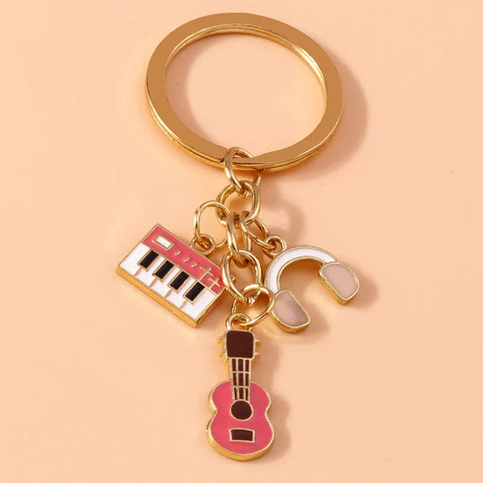 Gold-toned aihua enamel musical keychain with pink keyboard white headphones and guitar charms for women girls diy
