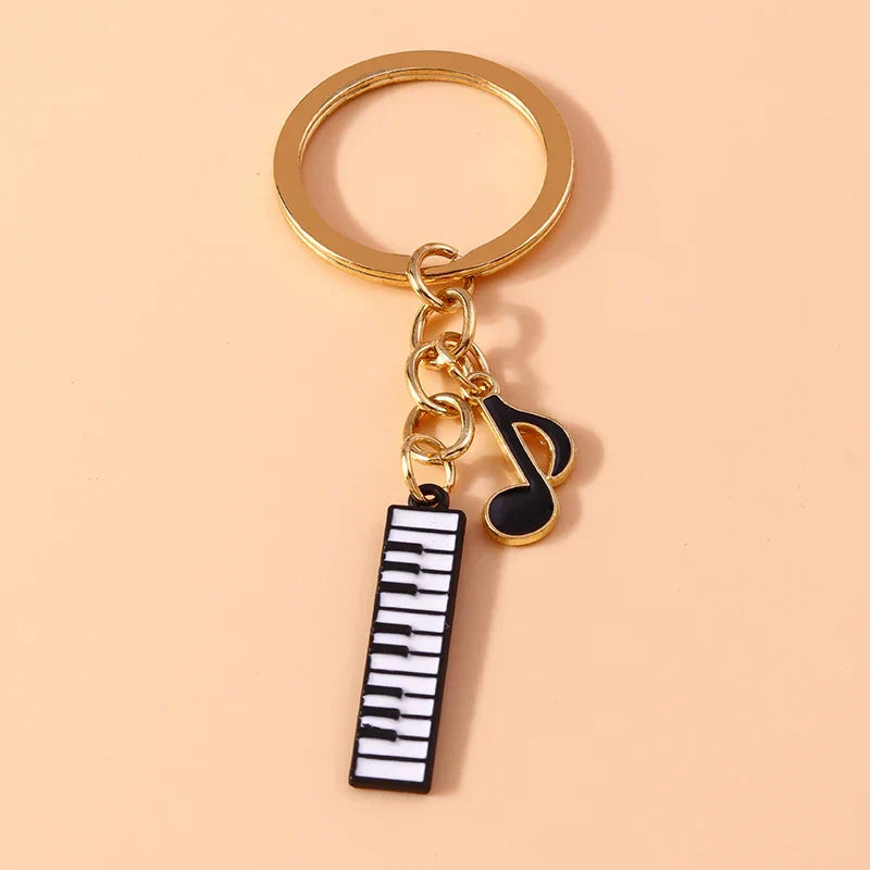 Gold-toned aihua enamel musical keychain with black and white piano keyboard charm and musical note pendant for women girls diy