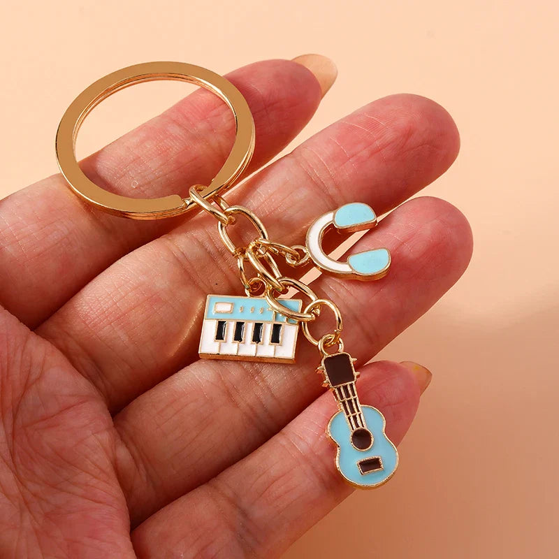 Gold-toned aihua enamel musical keychain with blue keyboard turquoise guitar and earbuds for women girls diy use