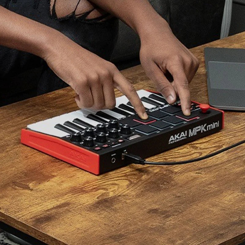 Akai professional mpk mini play mk3 plus midi keyboard arranger music controller in red and black with white and black keys