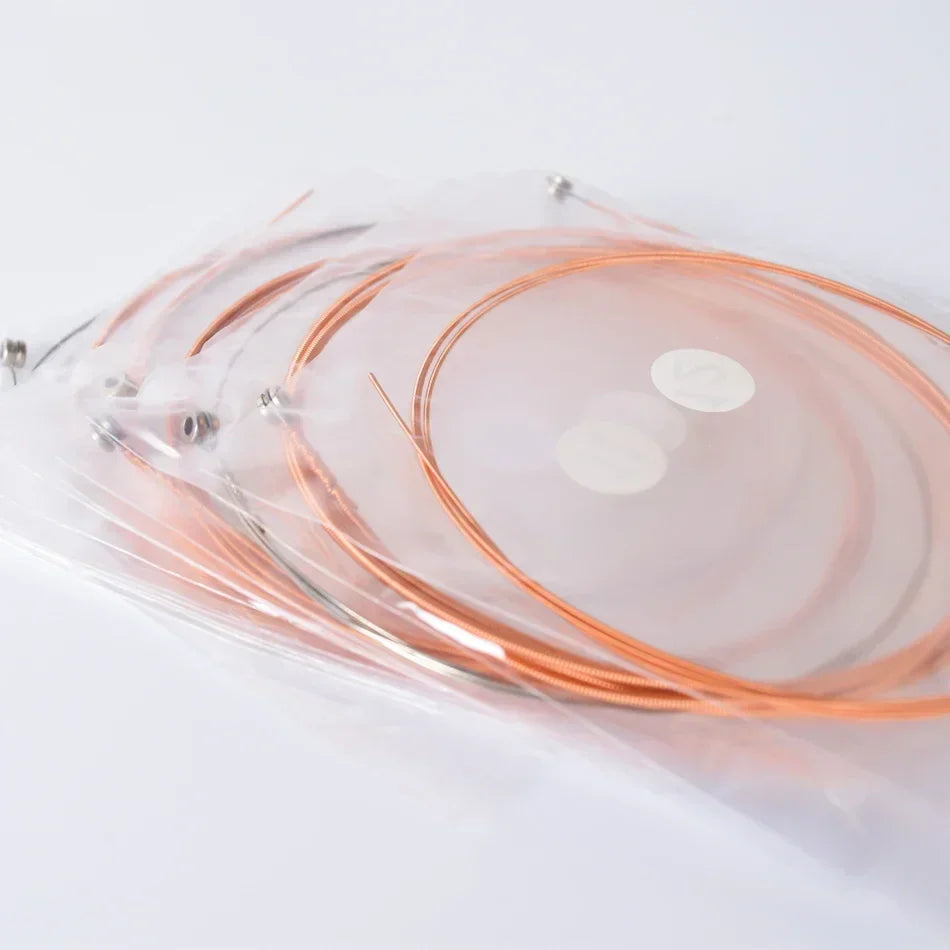 A set of alice a2012 copper-colored coated copper alloy strings acoustic guitar neatly coiled in clear plastic bag