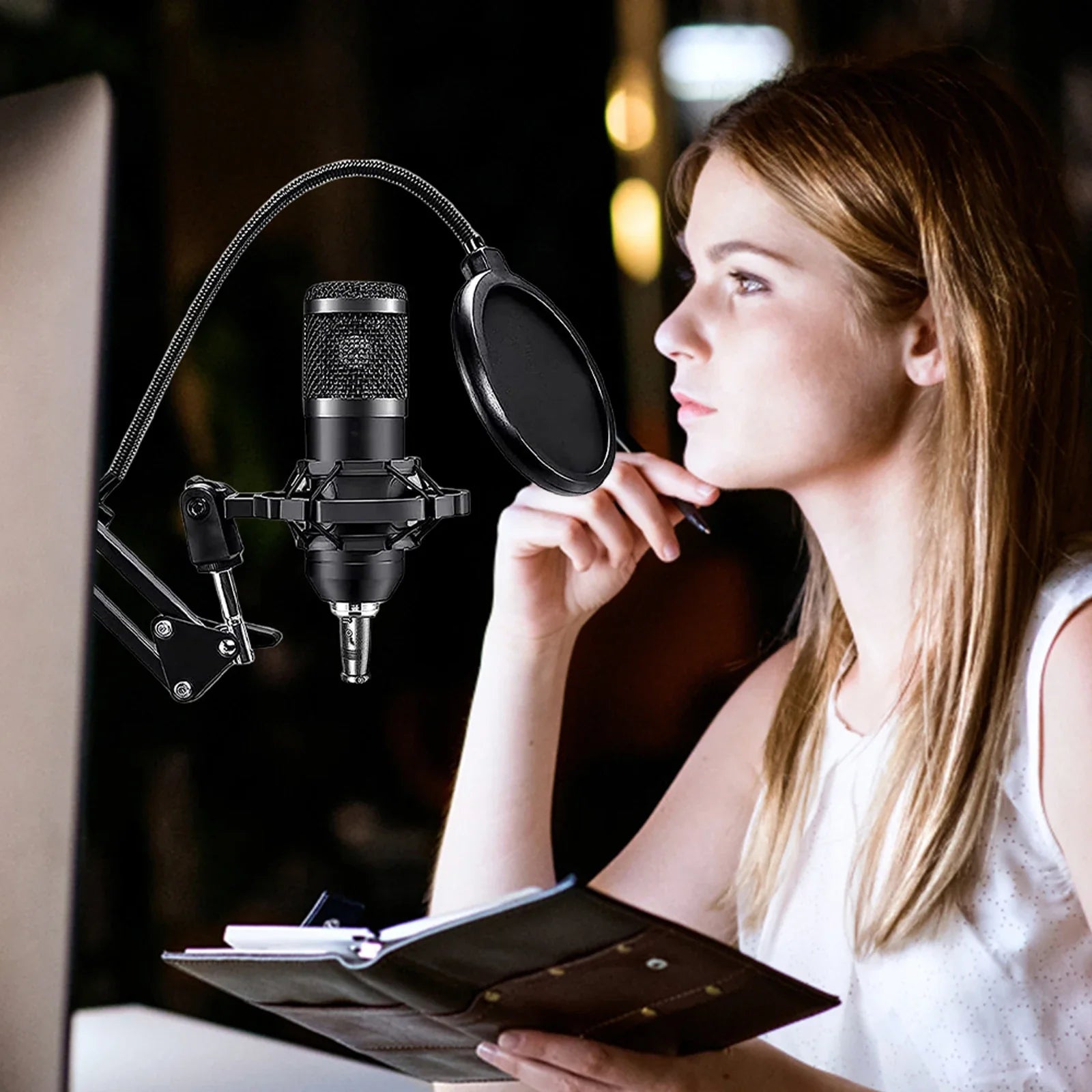 Black condenser microphone with pop filter and flexible gooseneck stand in recording studio package podcast equipment bundle