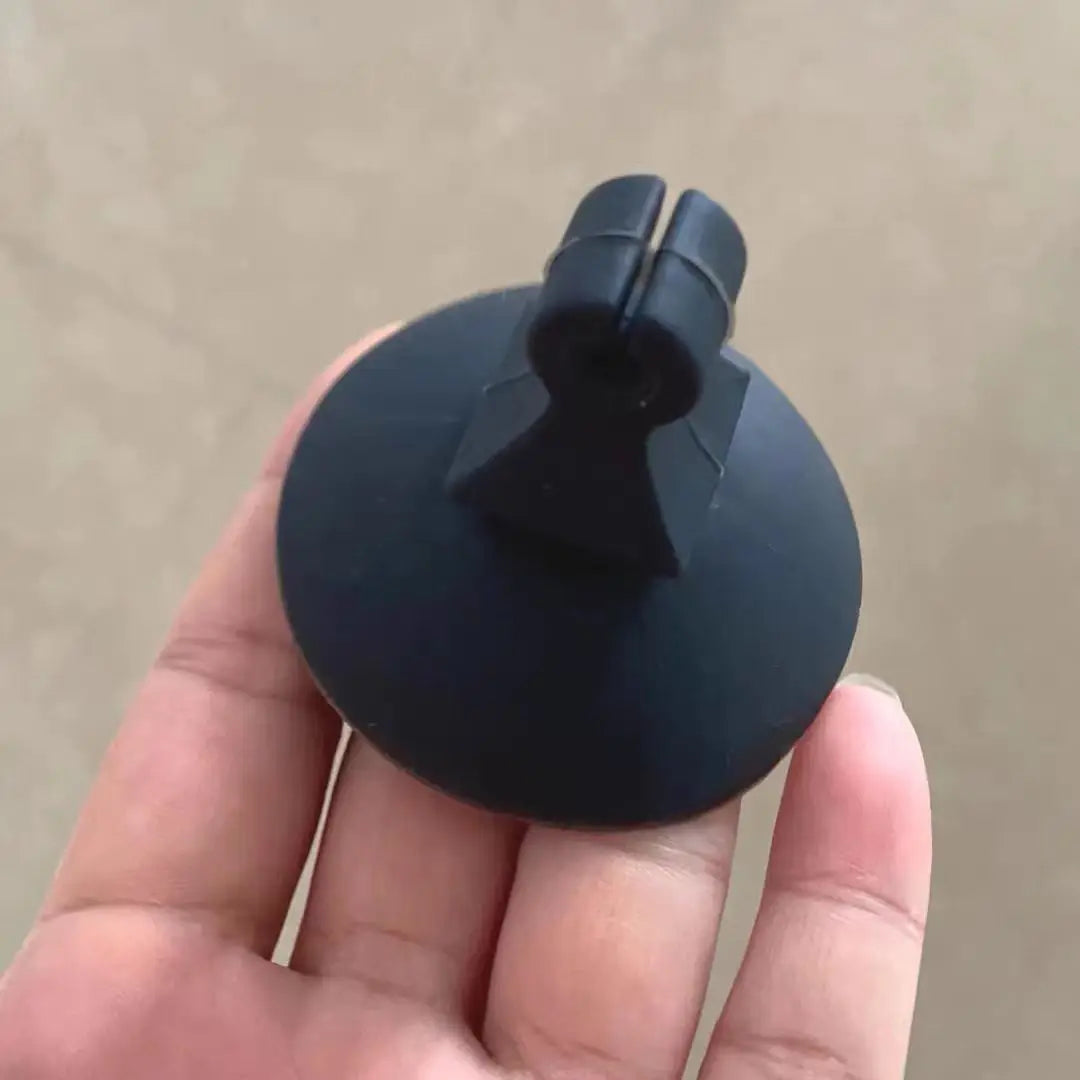 Black plastic suction cup with central stem for mounting musical instrument microphone clips violin and mic clamps stringed use