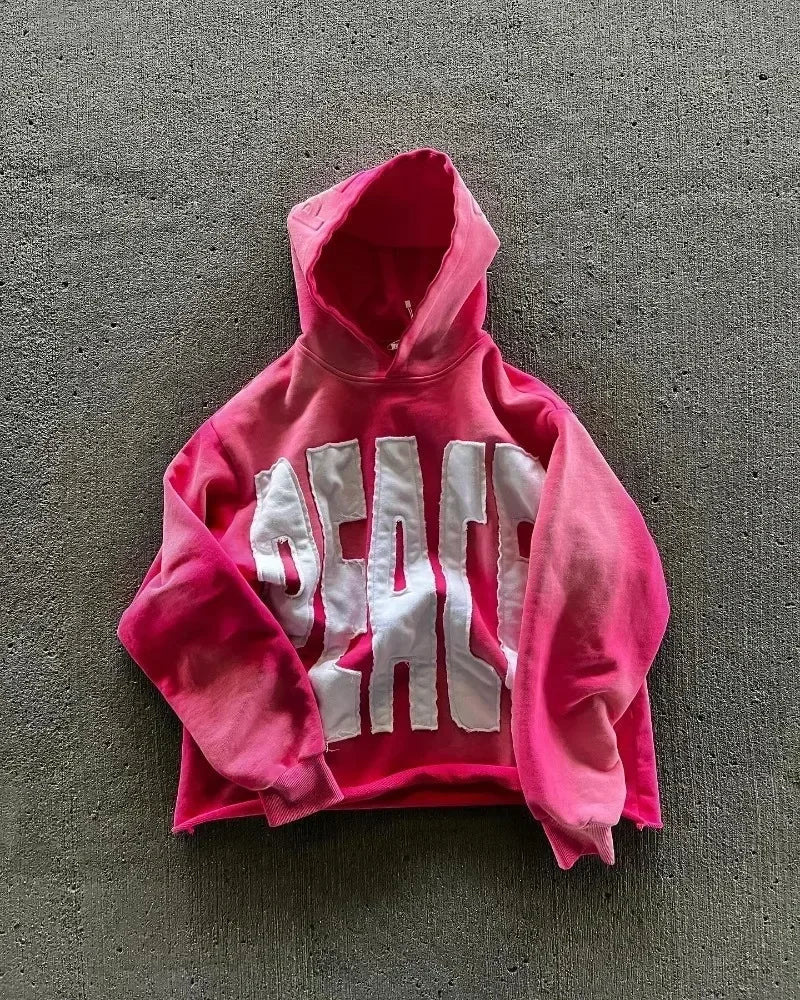 A vibrant pink cropped hoodie men y2k with bold white peace lettering perfect for gothic couple casual and joker streetwear