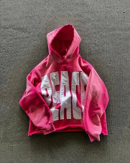 A vibrant pink cropped hoodie men y2k with bold white peace lettering perfect for gothic couple casual and joker streetwear