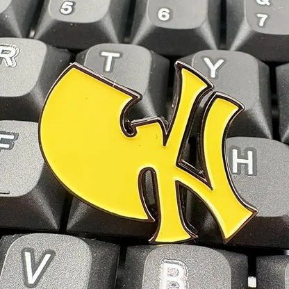 A vibrant yellow enamel brooch east featuring a wu-tang clan baseball team logo for music brand lapel pin fans gift