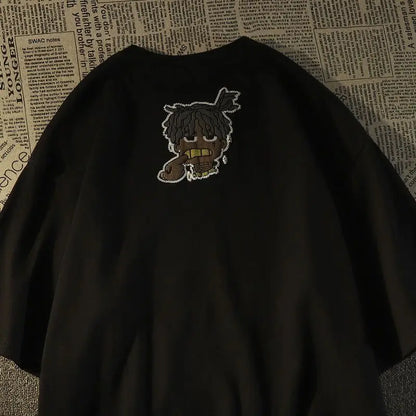 Black oversized short sleeve t-shirt with white embroidered cartoon dreadlocks and gold teeth for American hip hop fashion