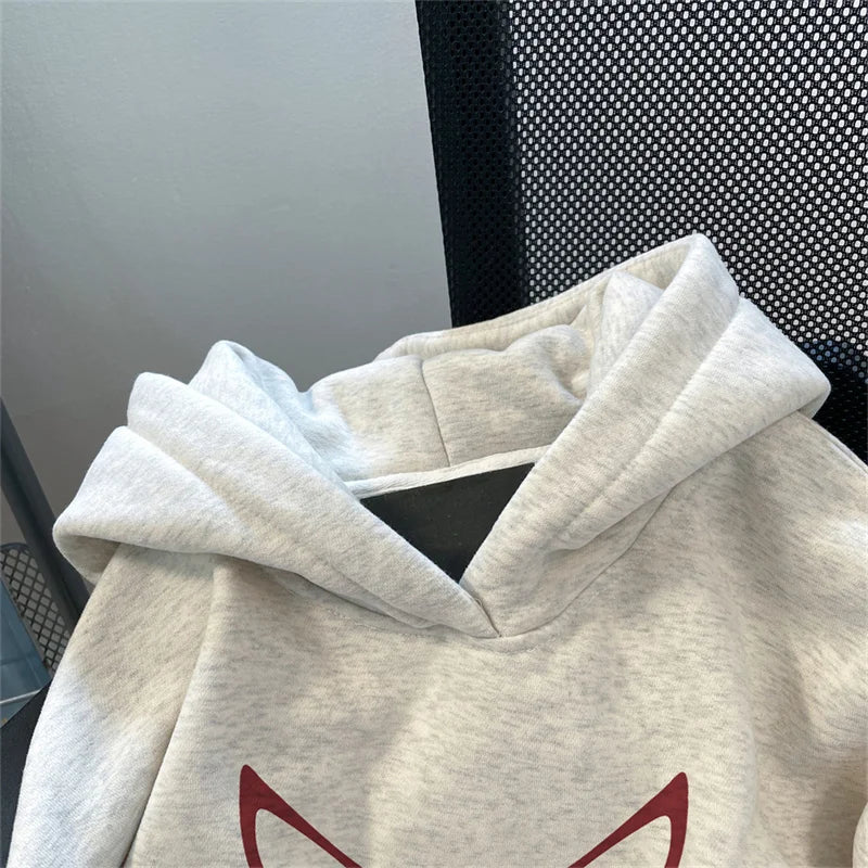 A soft heathered gray fleece y2k streetwear hoodie with cozy hood and red devil graphic for american hip hop style