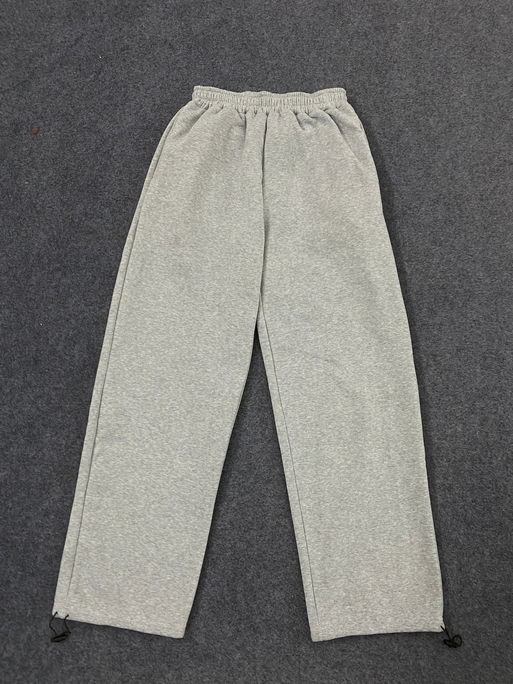 Gray heathered sweatpants with elastic waistband and ankle drawstrings featuring american hip hop personality design