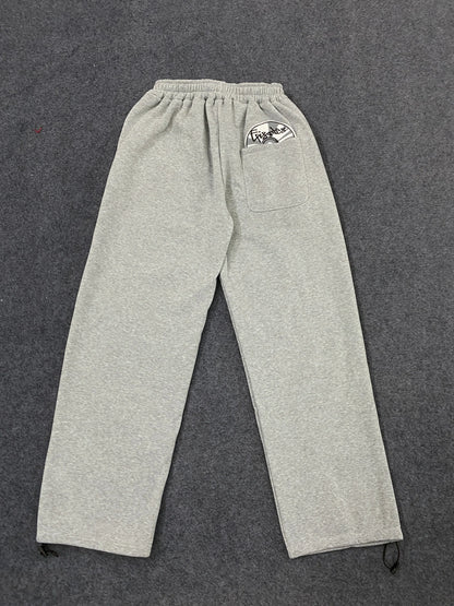 Gray heathered sweatpants with drawstring waist and side pockets showing back pocket logo in american hip hop street trendy pants